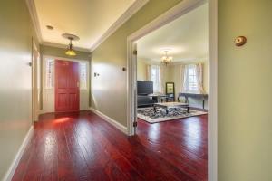 an empty hallway with a red door and a living room at 6B Luxury Rustic Farm Manor In Lang Lang in Lang Lang