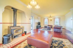a living room with a fireplace and a couch at 6B Luxury Rustic Farm Manor In Lang Lang in Lang Lang