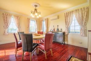 a dining room with a table and chairs at 6B Luxury Rustic Farm Manor In Lang Lang in Lang Lang