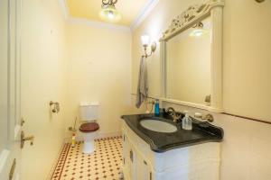 a bathroom with a black sink and a toilet at 6B Luxury Rustic Farm Manor In Lang Lang in Lang Lang