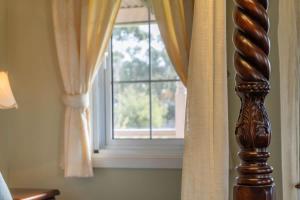 a bedroom with a window and a wooden curtain at 6B Luxury Rustic Farm Manor In Lang Lang in Lang Lang