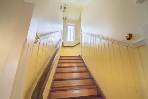 a hallway with wooden stairs and a window at 6B Luxury Rustic Farm Manor In Lang Lang in Lang Lang