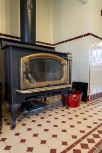 a fireplace in a room with a tiled floor at 6B Luxury Rustic Farm Manor In Lang Lang in Lang Lang