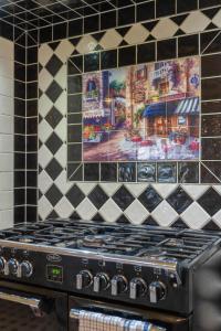 a stove top in a kitchen with a tile wall at 6B Luxury Rustic Farm Manor In Lang Lang in Lang Lang