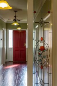 a room with a red door and a glass window at 6B Luxury Rustic Farm Manor In Lang Lang in Lang Lang