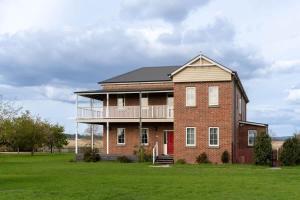 a large brick house with a large yard at 6B Luxury Rustic Farm Manor In Lang Lang in Lang Lang