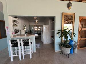 a kitchen with a counter and stools in a room at Casa Punta Perula Boutique Hotel in Pérula +24 photos