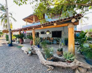 a house with a lot of plants in front of it at Casa Punta Perula Boutique Hotel in Pérula
