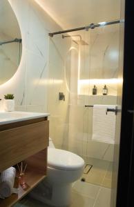 a bathroom with a toilet and a sink and a shower at La Haus Paipa beautiful and modern house in Paipa +21 photos