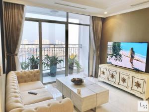 a living room with a tv and a large window at Saigon Landmark Cityview Apartment - PYG in Ho Chi Minh City