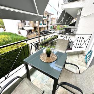 a balcony with a table and chairs on a balcony at R&T Apartments in Kallithea Halkidikis