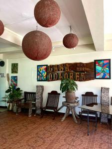 a lobby with chairs and potted plants in a building at Casa Dolores Laiya Batangas in San Juan