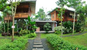 ein Haus mit einem Weg davor in der Unterkunft Forrest Cafe & Wisata Berkuda in Jengkol