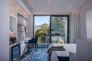 a hotel room with a bed and a balcony at Ergina Boutique Experience in Sisi