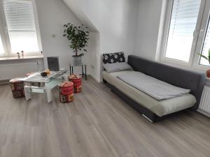 a living room with a couch and a table at Haus Eldena in Greifswald