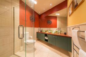 a bathroom with a shower and a toilet at Titore Lodge in Russell +16 photos