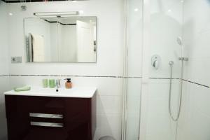 a bathroom with a sink and a shower with a mirror at St Germain in Moraira +12 photos