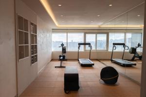 a gym with treadmills and exercise equipment in a building at Eliena Hotel Seoul Gangnam in Seoul