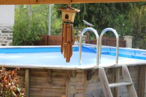 a swimming pool with a bird house on top of it at Le Val Insolite in Lieuron
