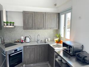 a kitchen with wooden cabinets and a sink and a microwave at SEA villa in Monolithos