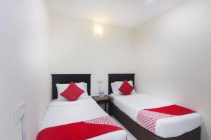 Postel nebo postele na pokoji v ubytování OYO 91130 Hotel 91 Bukit Mewah
