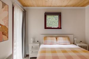 a bedroom with a bed and a window at Cora Lynn - Apartment 3 in Lorne