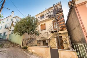a building with a fire escape on the side of it at Mytilene Central Home 2 in Mytilini