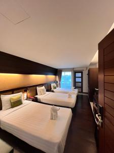 a hotel room with two beds and a window at Nordwind Hotel in Chiang Mai +148 photos
