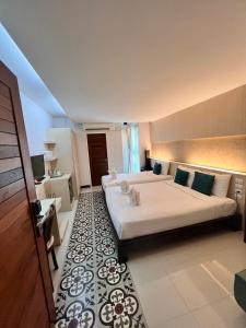 a large bedroom with two beds and a rug at Nordwind Hotel in Chiang Mai