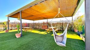 a hammock hanging from a pavilion in a garden at Area Parking Caravane in Seville