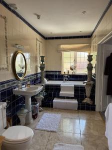 a bathroom with a tub and a toilet and a sink at West ave exeter in Exeter +54 photos