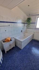 a large bathroom with a tub and a sink at Ferienwohnung Wiesental II, Wiesentalstrasse 1, 89331 Burgau in Burgau +34 photos