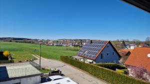 a house with solar panels on the roof at Ferienwohnung Wiesental II, Wiesentalstrasse 1, 89331 Burgau in Burgau