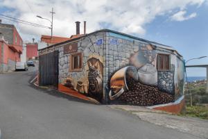 a wall with a painting of a train on it at El Rincon Del Viajero Gran Canaria in Santidad