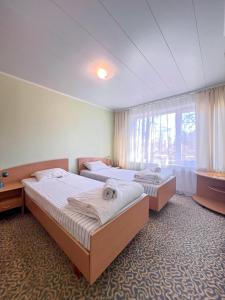 Postel nebo postele na pokoji v ubytování Park Hotel Kekava