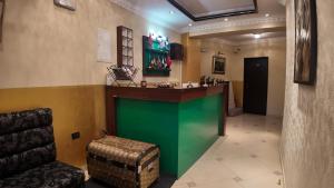 a hotel lobby with a green and green counter at Hotel Shadervan in Prizren