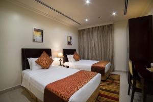מיטה או מיטות בחדר ב-Al Rashid Residence
