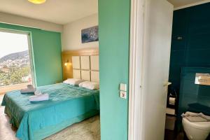 A bed or beds in a room at Hotel Apartments Panorama