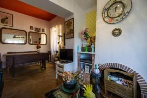 a living room with a piano and a clock on the wall at Cascais Boutique Hostel in Cascais