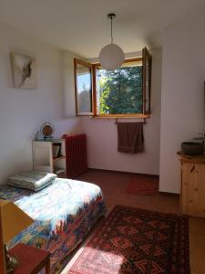 a bedroom with a bed and a window and a rug at Chambre ensoleillée au calme in Lasalle