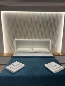 a bedroom with a bed with two towels on it at RealeBorbonica-Intero Appartamento Con Ampio Terrazzino in Portici