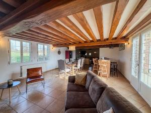 a living room with a couch and a table at La longère de Guitôt in La Ferté en Ouche