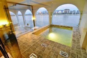 a bath tub with a view of the water at เลอค่าเชียงแสน Le Quar Cafe BistroBed & Breakfast in Golden Triangle