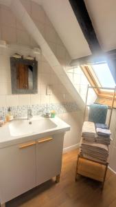 a white bathroom with a sink and a window at The Cottage By The Sea, Scotland in Burnmouth