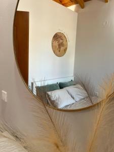 a mirror on a wall with a bed in a room at Salitzo Apartment Palairos in Paleros