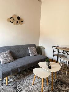 a living room with a couch and two tables at Salitzo Apartment Palairos in Paleros
