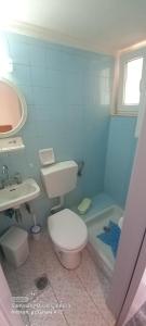 a bathroom with a toilet and a sink and a tub at Maria,s house in Petra +9 photos