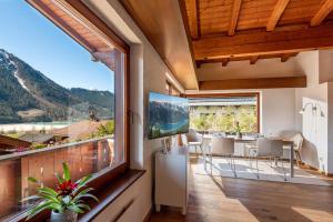 a room with a balcony with a view of a mountain at Haus Auszeit in Buchau