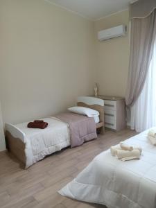 a bedroom with two beds and a window at Luminoso Appartamento con Terrazza......C.U......Q2483 in Sìnnai