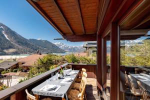 a table on a balcony with a view of the mountains at Haus Auszeit in Buchau